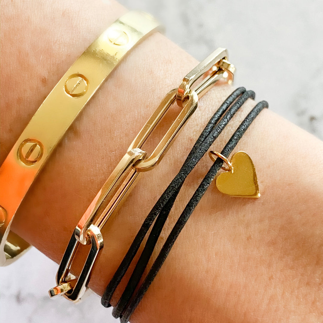 leather 14 kt. gold heart charm bracelet, 14 kt. gold long paperclip chain bracelet and gold Cartier Love Bracelet